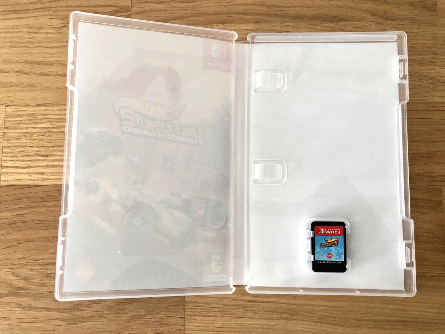 Inside the case of Hot Wheels Unleashed 2 Turbocharged for Nintendo Switch, showing the cartridge and case design.
