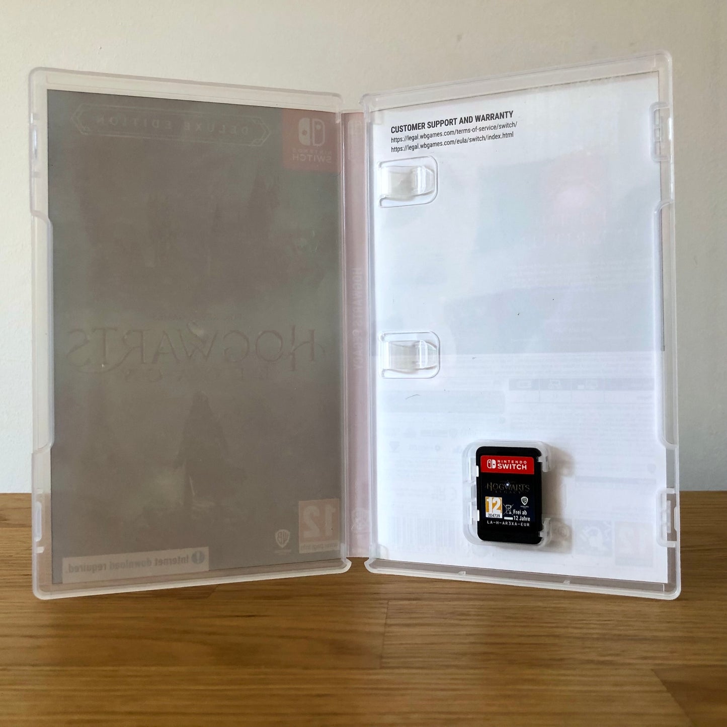 Inside the case of Hogwarts Legacy for Nintendo Switch, showing the cartridge and case design.