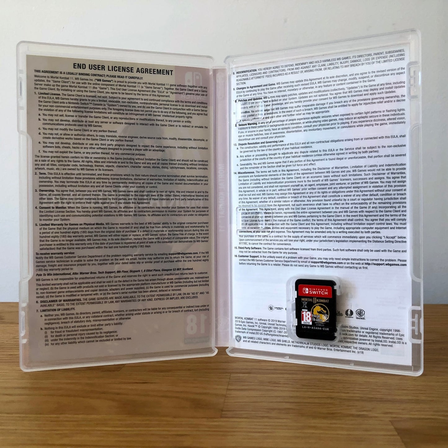 Inside the case of Mortal Kombat 11 for Nintendo Switch, showing the cartridge and case design.