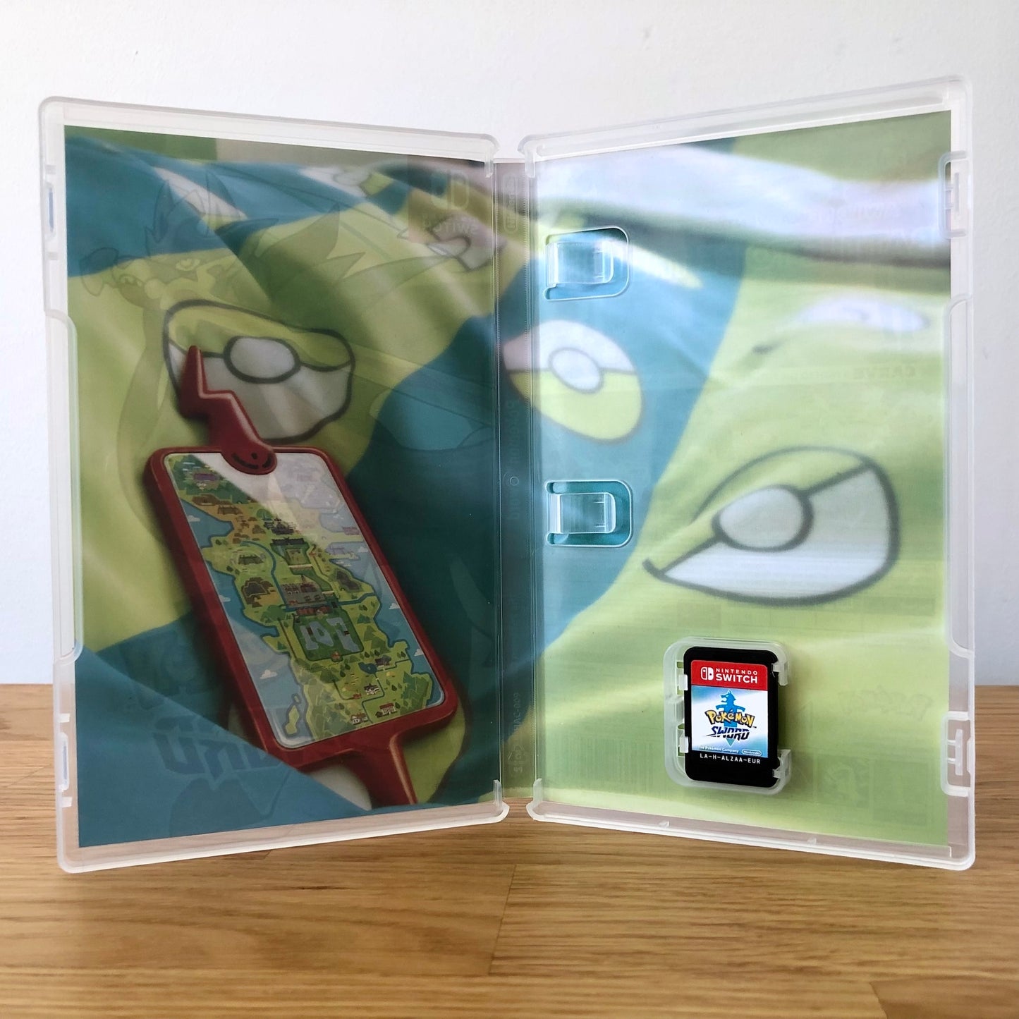 Inside the case of Pokémon Sword for Nintendo Switch, showing the cartridge and case design.