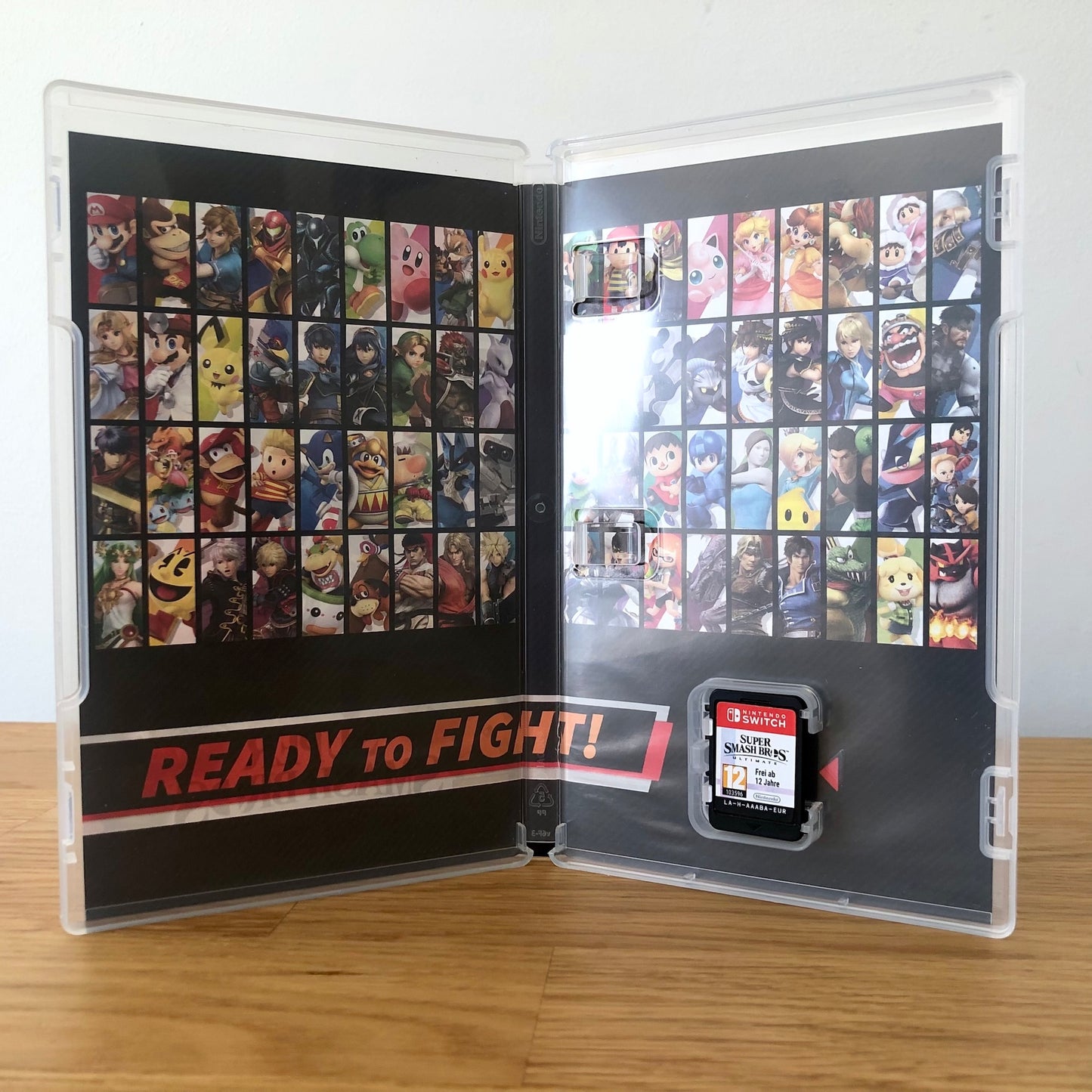 Inside the case of Super Smash Bros. Ultimate for Nintendo Switch, showing the cartridge and case design.
