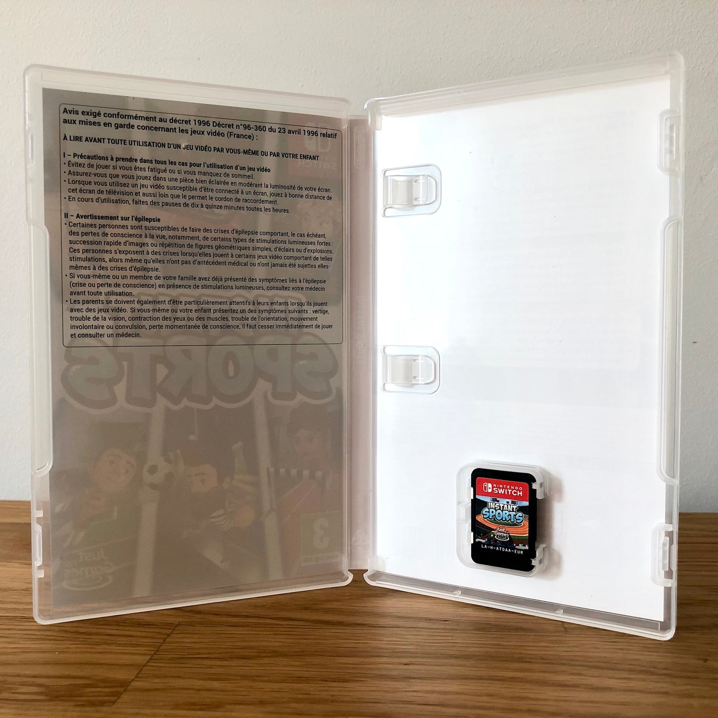 Inside the case of Instant Sports for Nintendo Switch, showing the cartridge and case design.