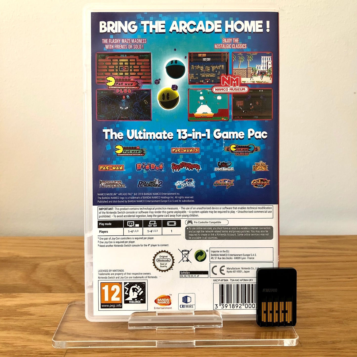 Back case cover of Namco Museum Arcade PAC for Nintendo Switch, showing game details, features, and back of cartridge.