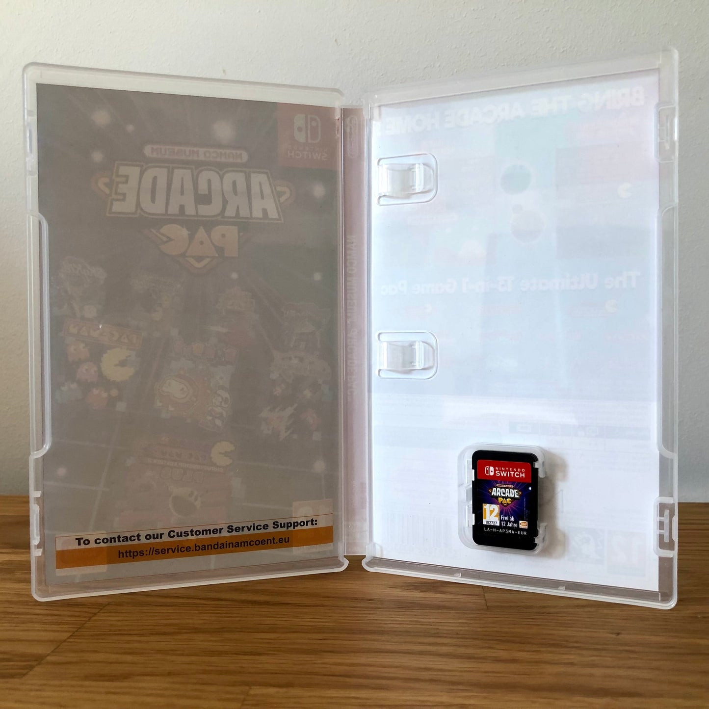 Inside the case of Namco Museum Arcade PAC for Nintendo Switch, showing the cartridge and case design.