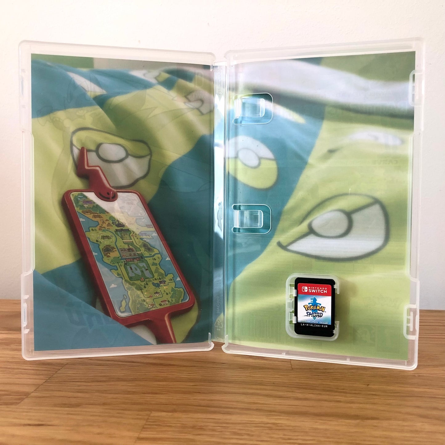 Inside the case of Pokémon Sword for Nintendo Switch, showing the cartridge and case design.