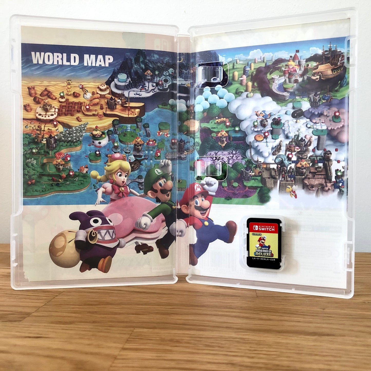 Inside the case of New Super Mario Bros. U Deluxe for Nintendo Switch, showing the cartridge and case design.