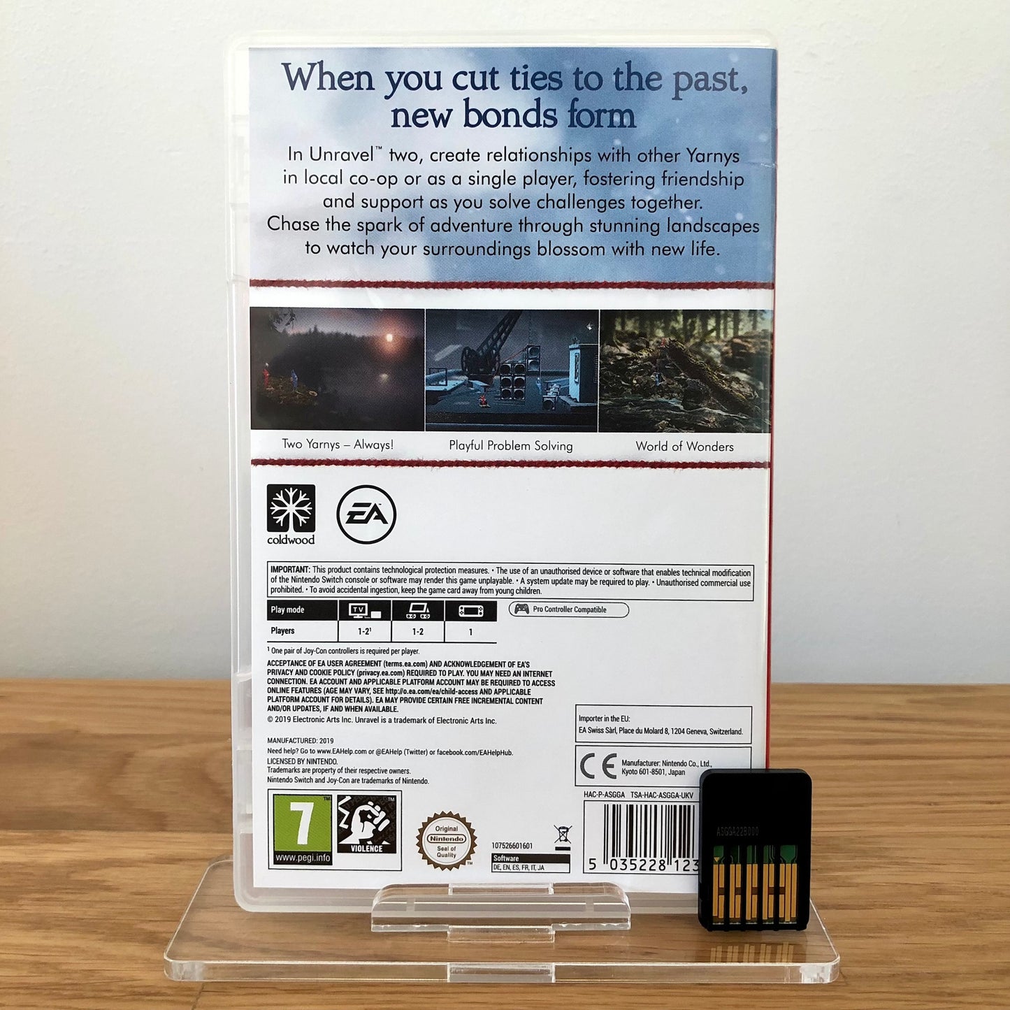 Back case cover of Unravel Two for Nintendo Switch, showing game details, features, and back of cartridge.