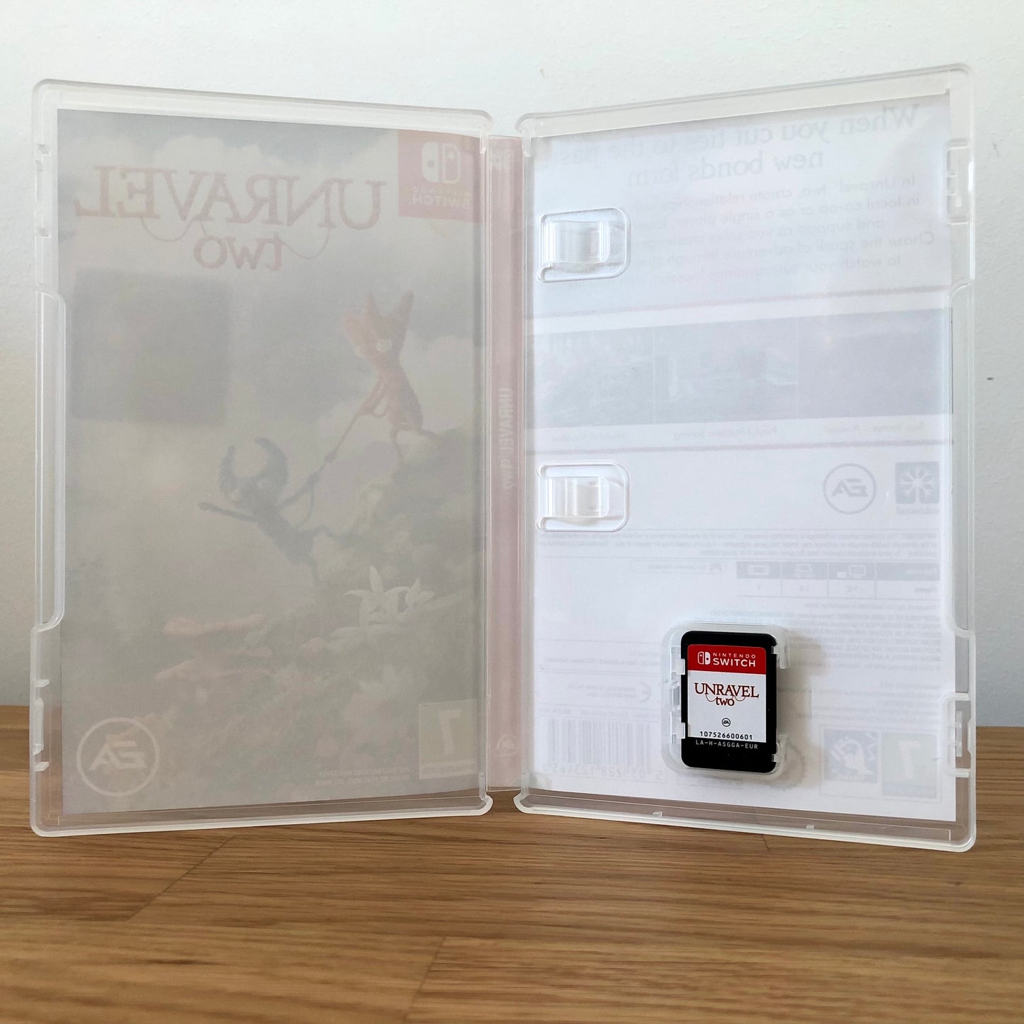 Inside the case of Unravel Two for Nintendo Switch, showing the cartridge and case design.