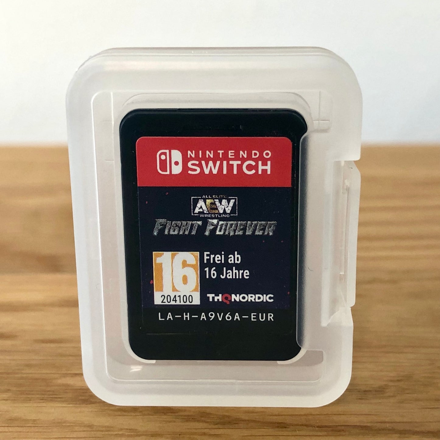 AEW: Fight Forever for Nintendo Switch, showing the cartridge inside protective case
