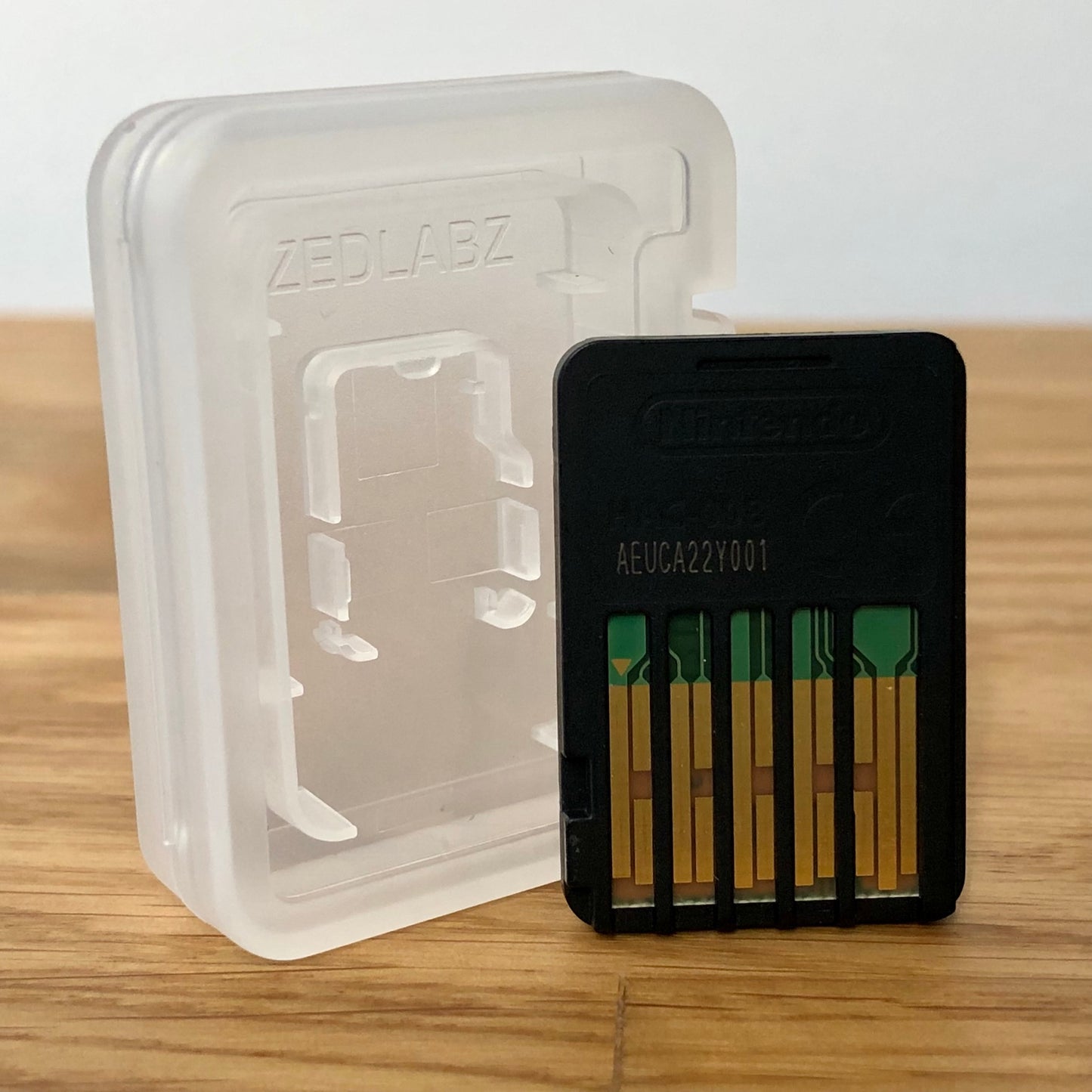 Nintendo Switch Minecraft back of game cartridge with a clear plastic case on a wooden surface