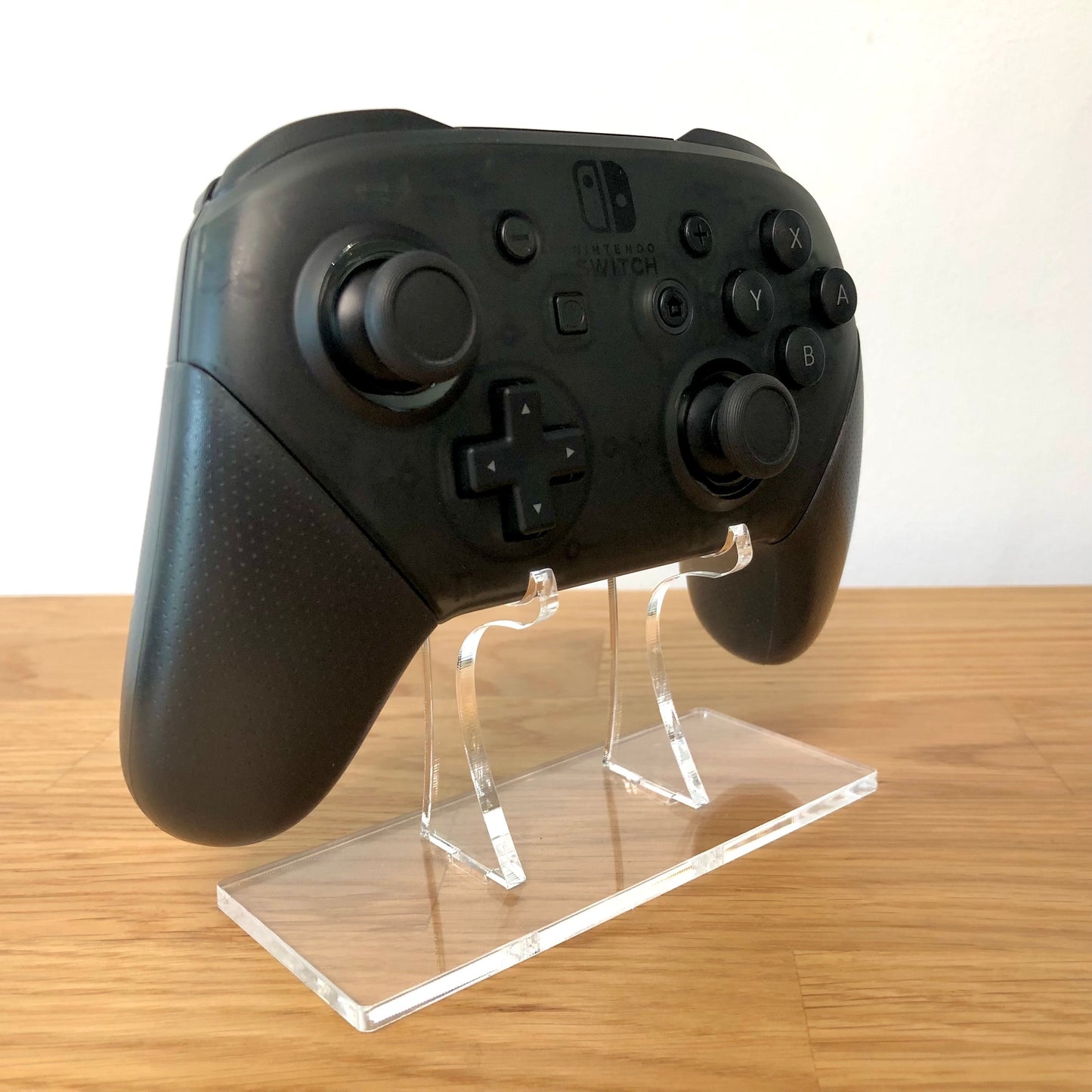 Side view of Nintendo Switch Pro Controller, showing button layout and ergonomic design.