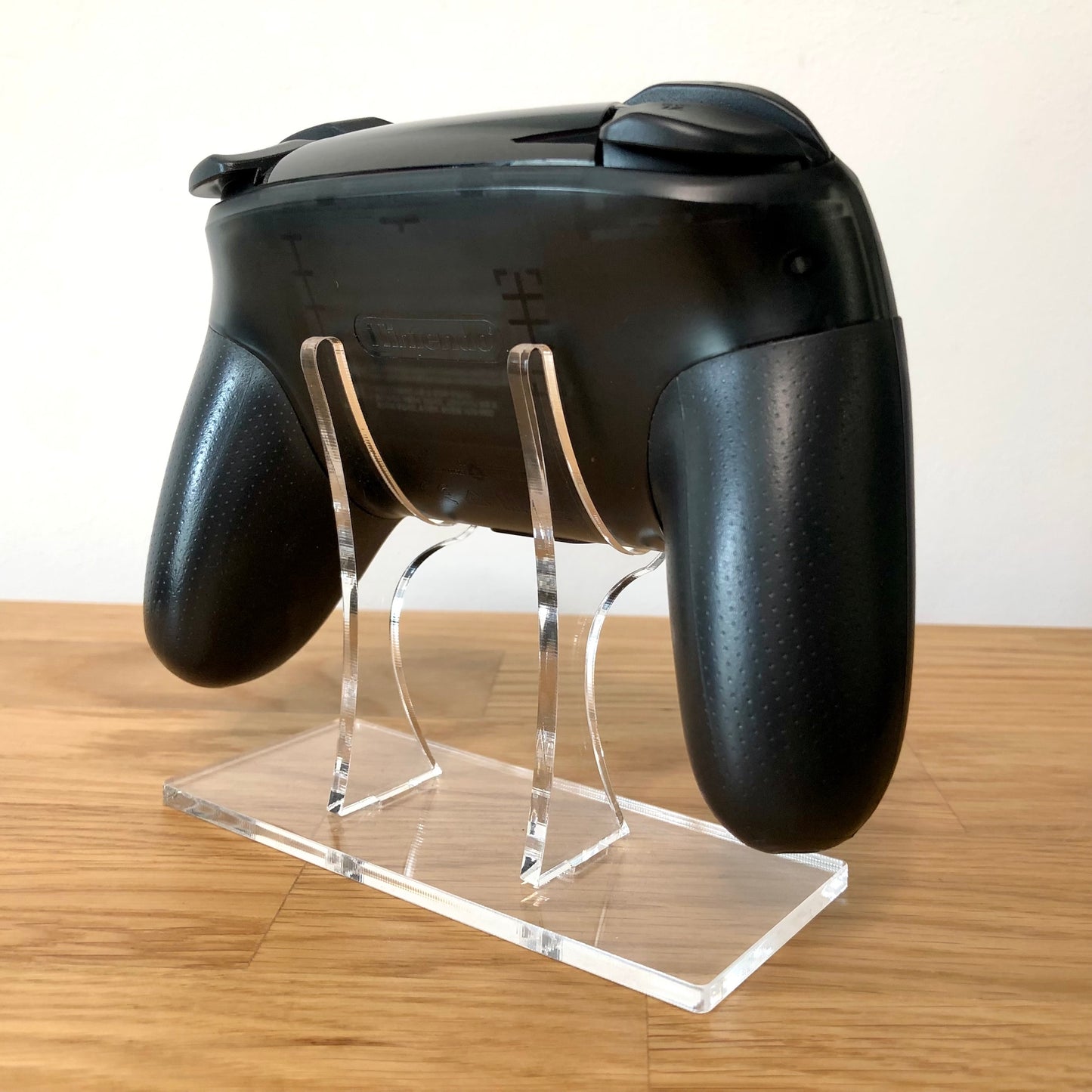 Back side view of Nintendo Switch Pro Controller, highlighting model details and rear design.