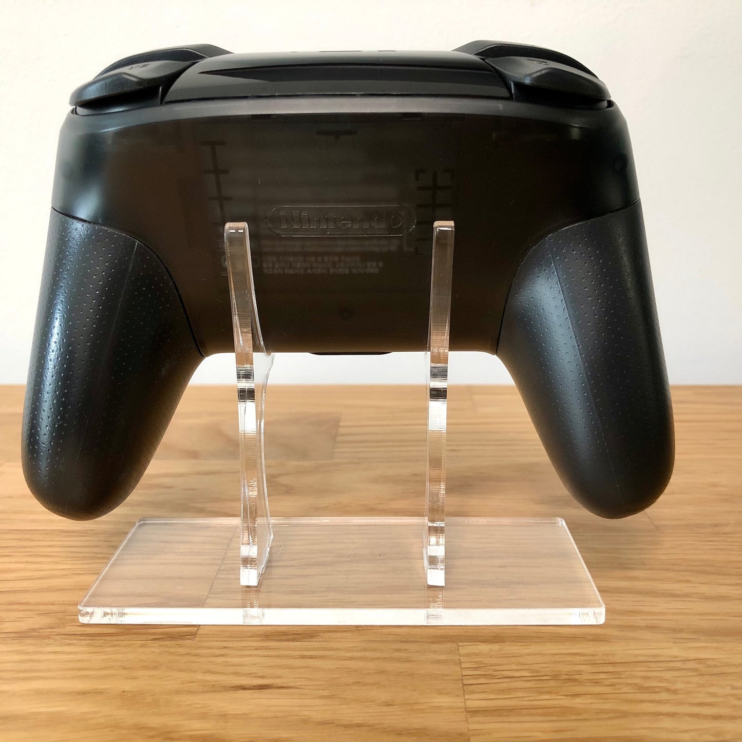 Back view of Nintendo Switch Pro Controller, highlighting model details and rear design.
