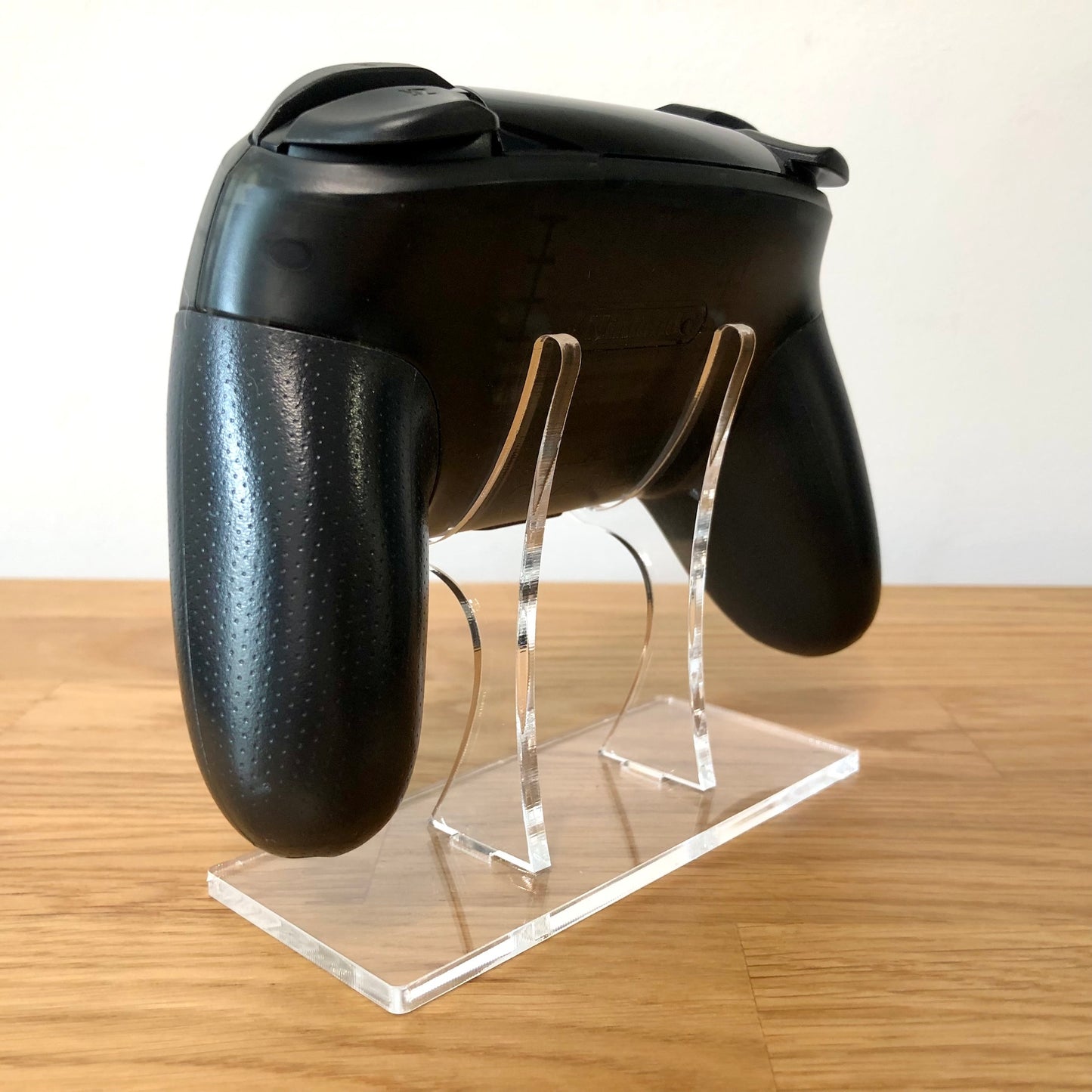 Back side view of Nintendo Switch Pro Controller, highlighting model details and rear design.