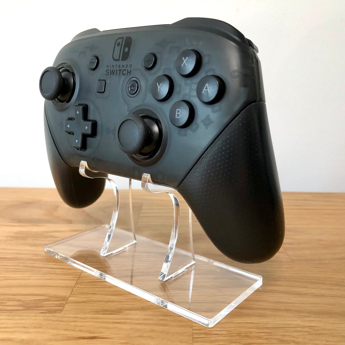 Front side view of Nintendo Switch Pro Controller, showing button layout and ergonomic design.