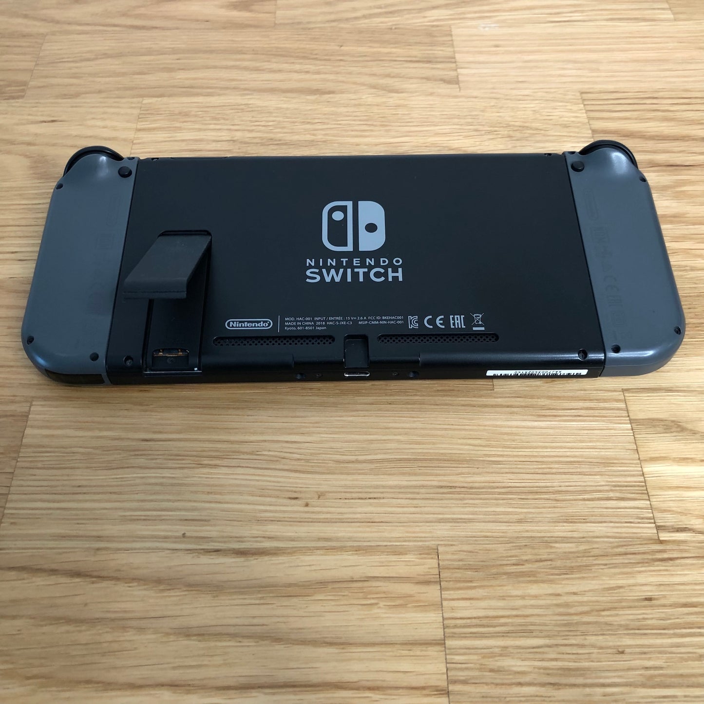 Bottom edge of Nintendo Switch console showing USB-C port, speaker vents and Joy-Con release buttons.