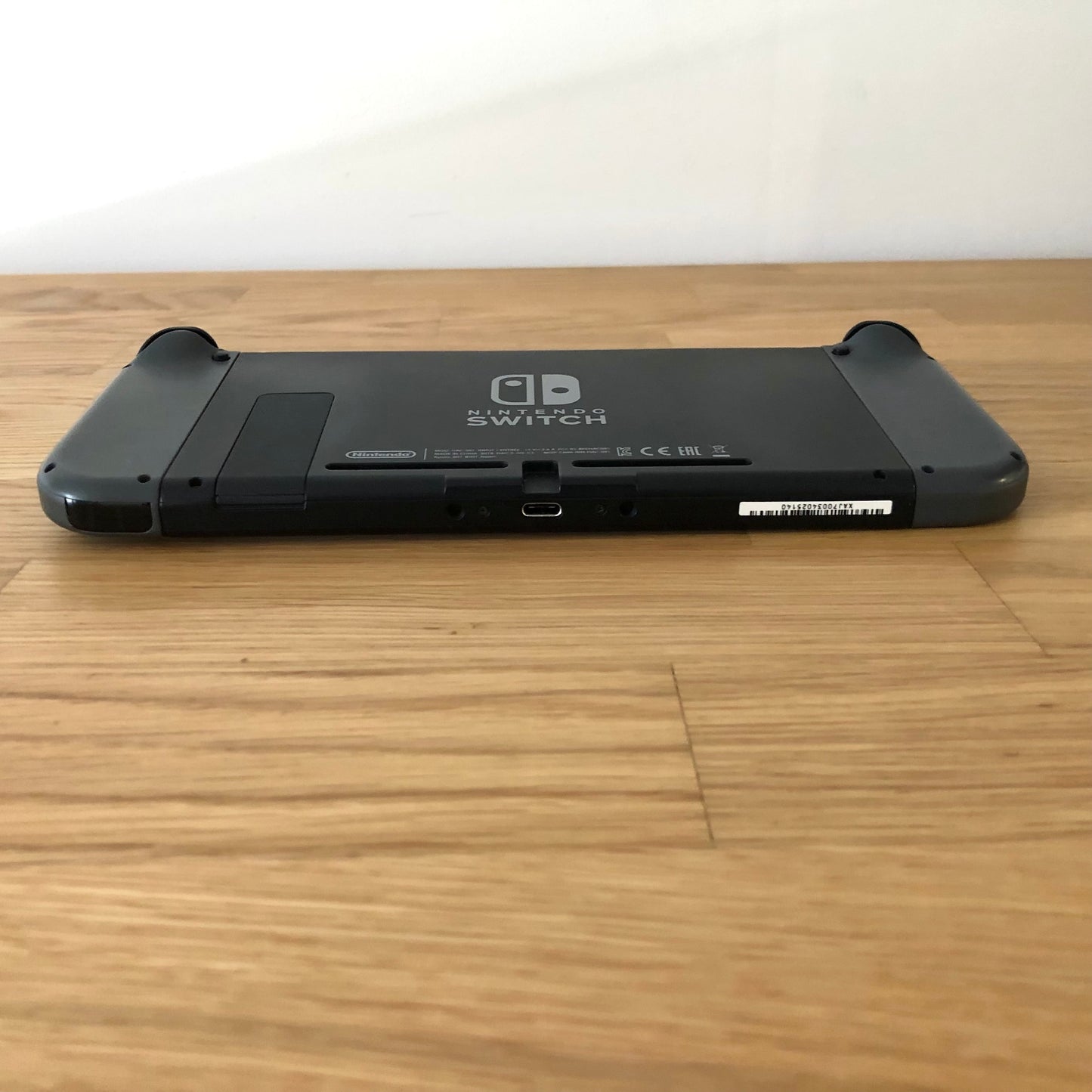 Bottom edge of Nintendo Switch console showing USB-C port, speaker vents and Joy-Con release buttons.