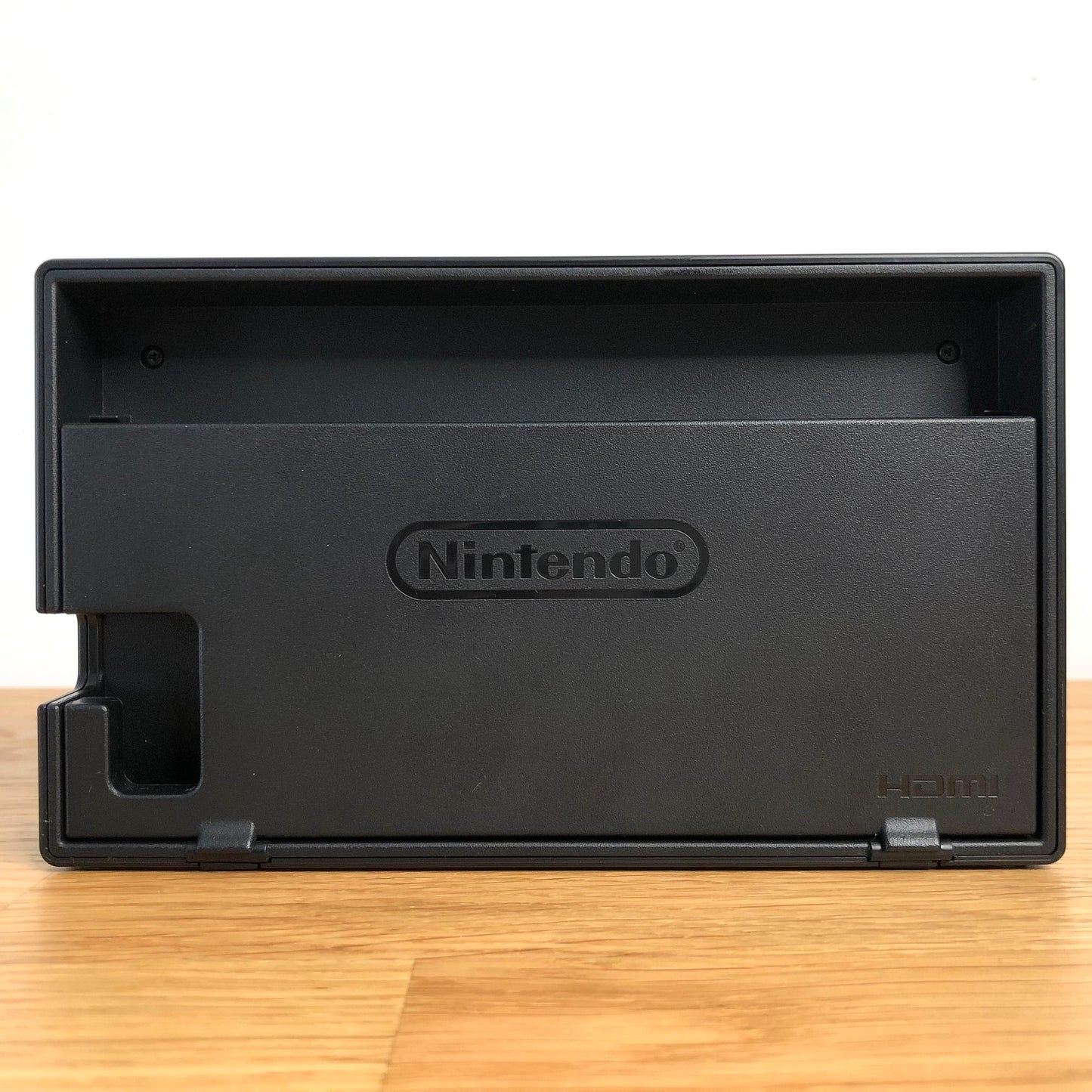 Rear of Nintendo Switch dock with HDMI branding and Nintendo logo, cable slot openings on left side.