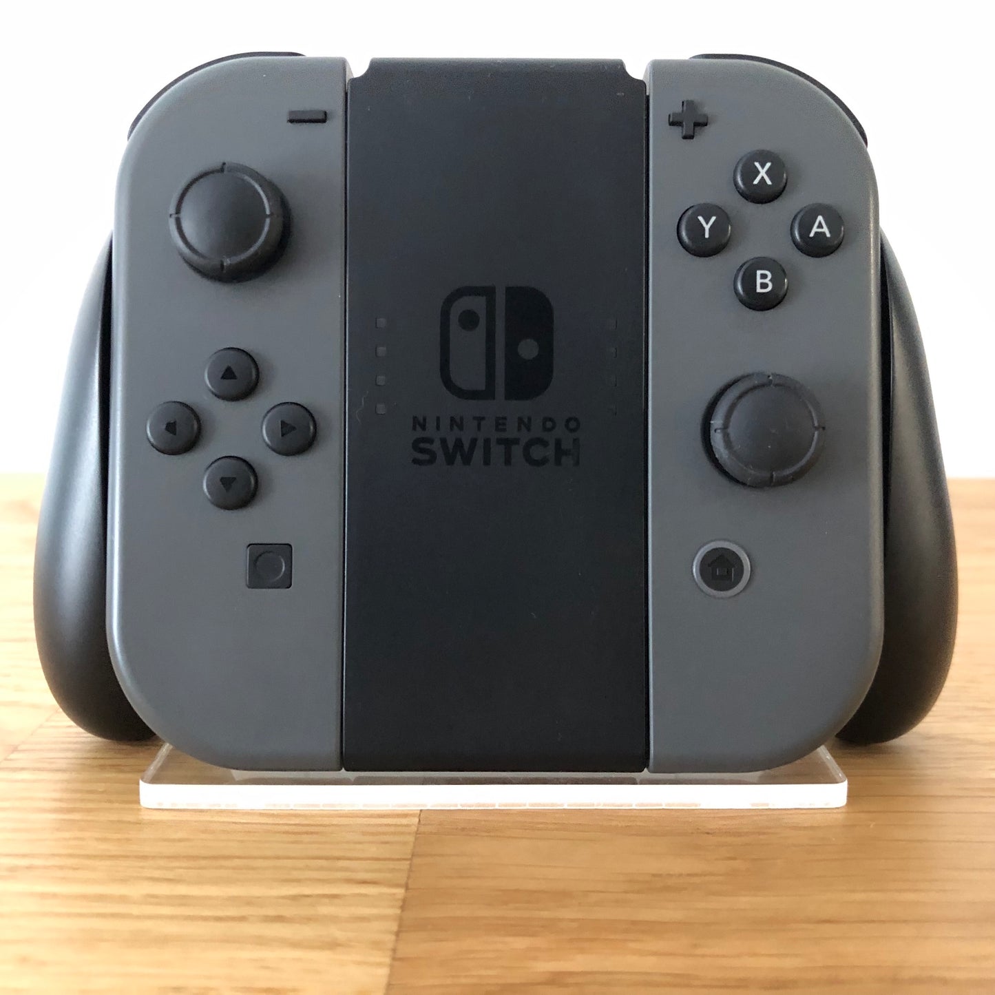 Front view of Joy-Con grip with grey Nintendo Switch Joy-Cons, showing all front facing buttons.