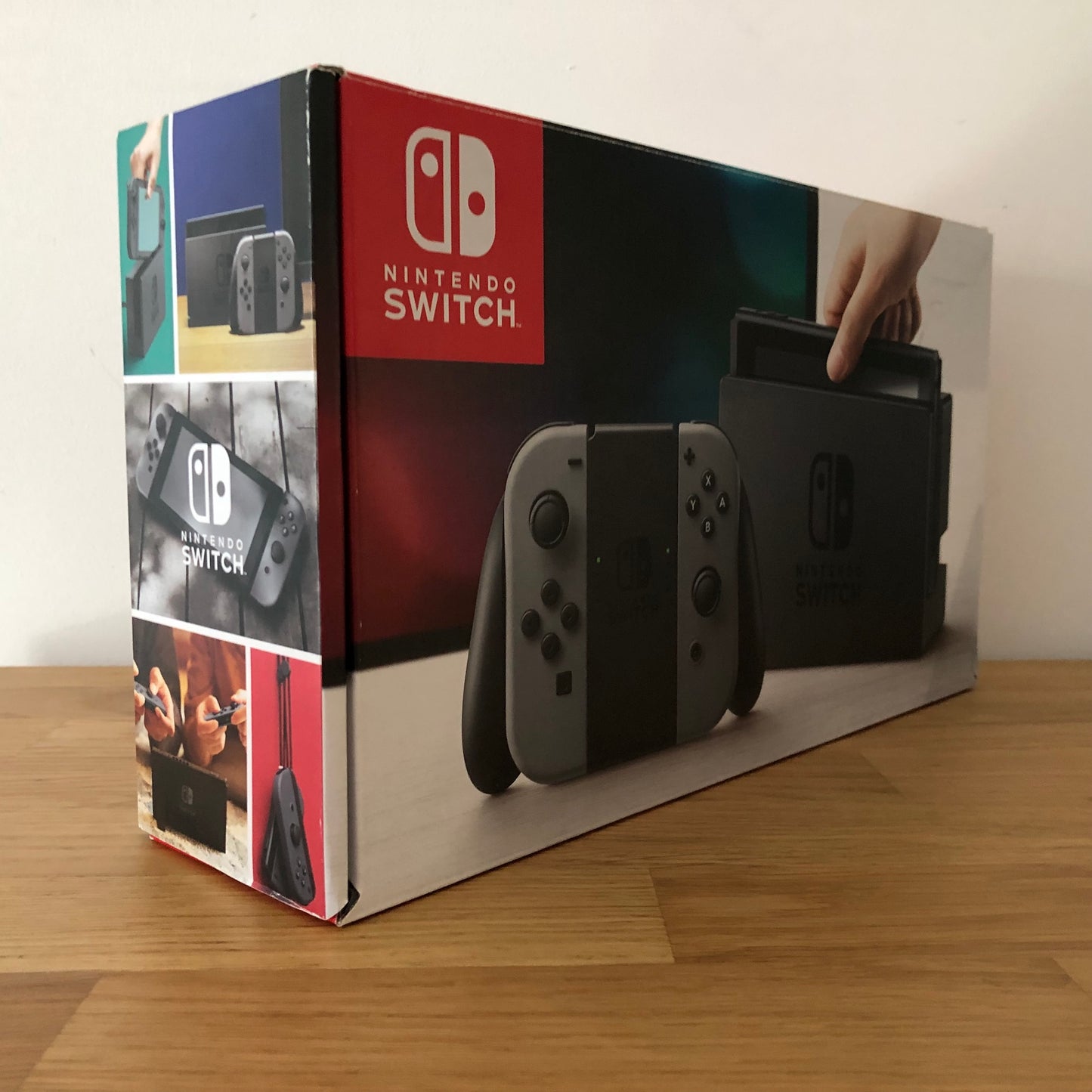 Angled side view of Nintendo Switch box showing branding, features and product images.