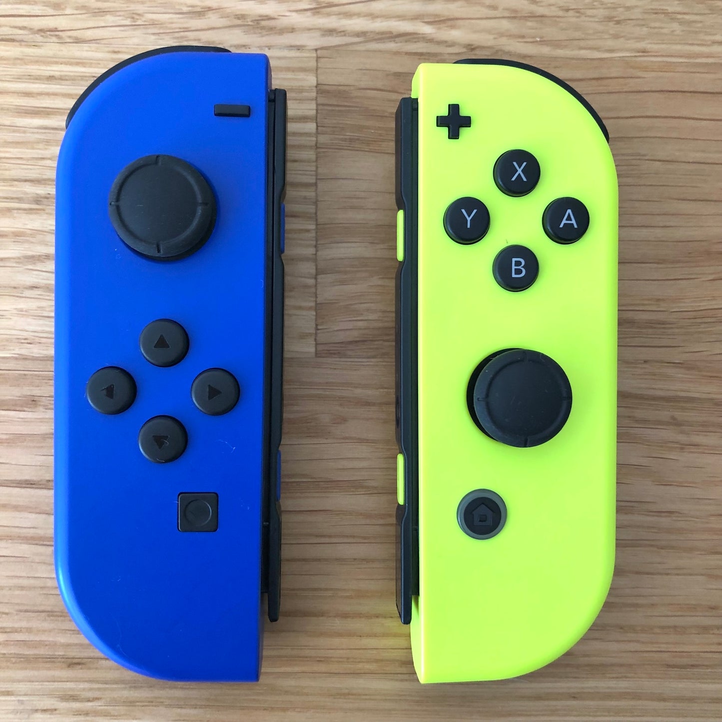 Birds eye top view of Blue & Neon Yellow Joy-Cons pair, showing button layout and design.