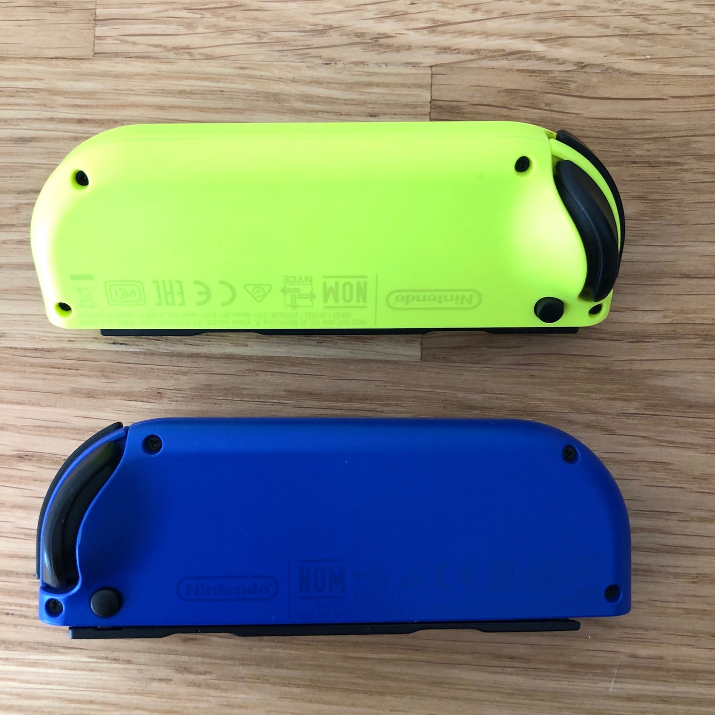 Birds eye top view of Blue & Neon Yellow Joy-Cons pair, showing the back of the Joy-cons.