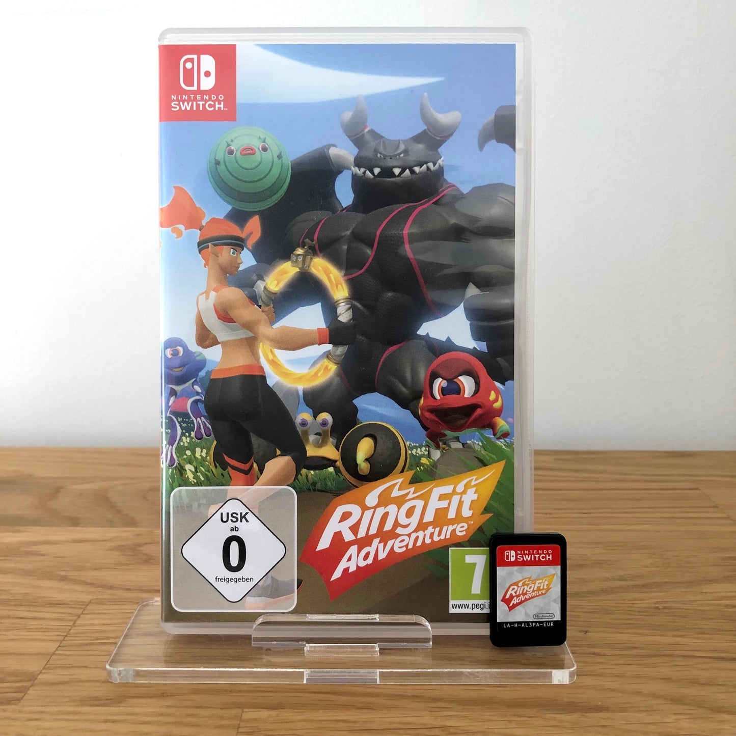 Front case cover of Ring fit adventure for Nintendo Switch, featuring game artwork, title, and front of cartridge.