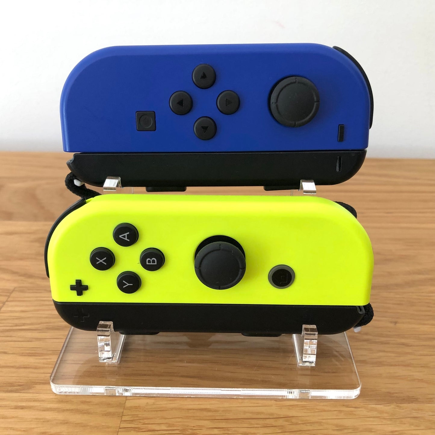 Front view of Blue & Neon Yellow Joy-Cons pair with supporting wrist straps attached, showing button layout and design.