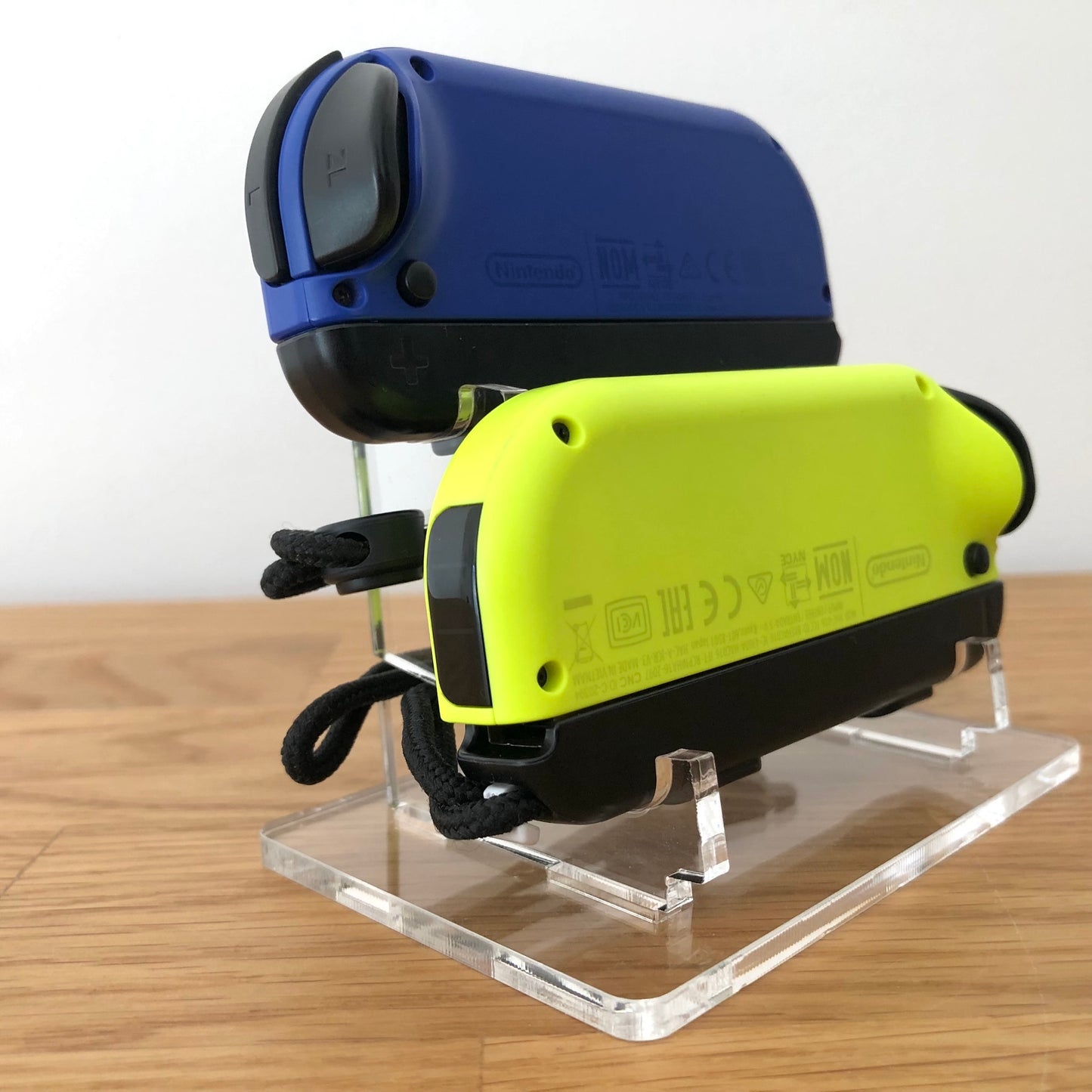 Diagonal rear angle of neon yellow and blue Nintendo Switch Joy-Con controllers showing top bumpers.