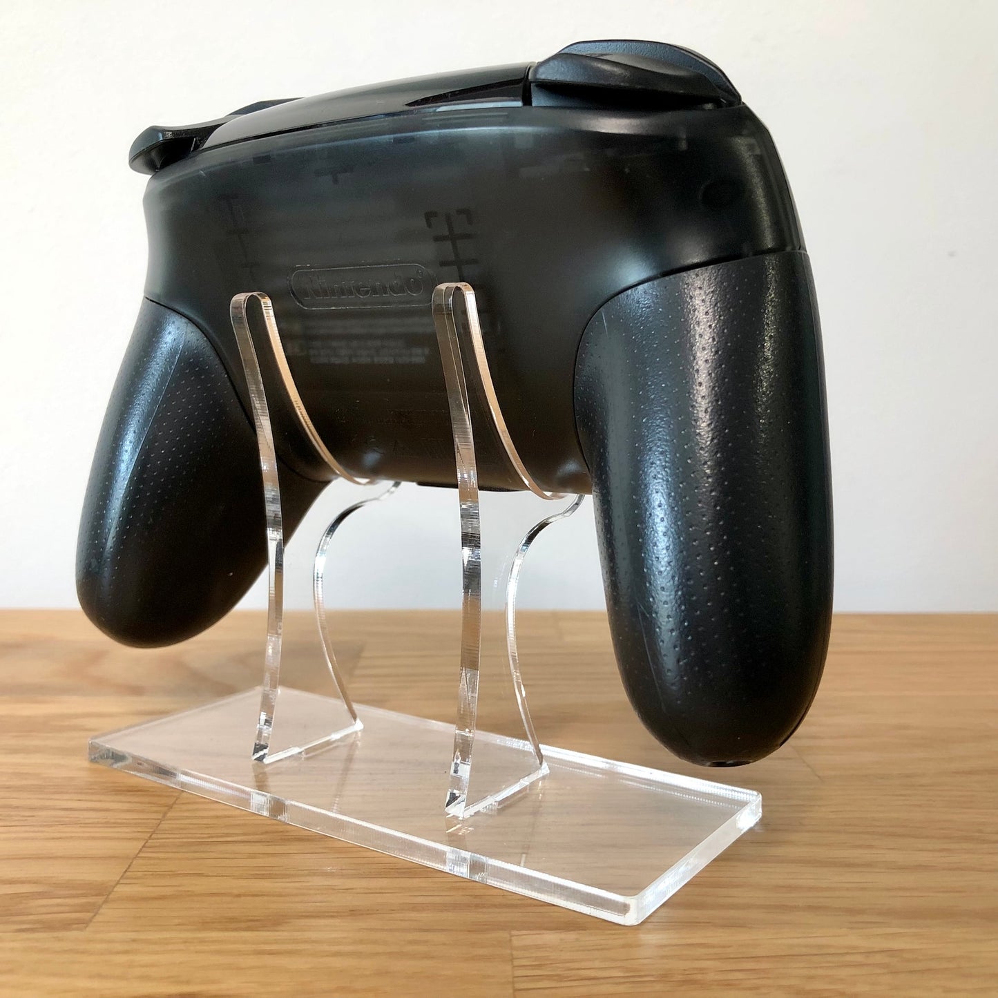 Back side view of Nintendo Switch Pro Controller, highlighting model details and rear design.