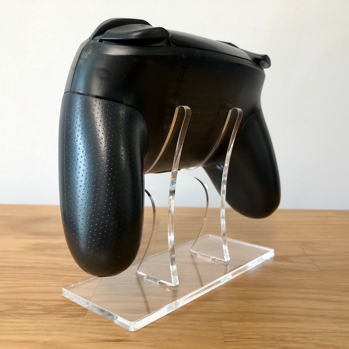 Back side view of Nintendo Switch Pro Controller, highlighting model details and rear design.