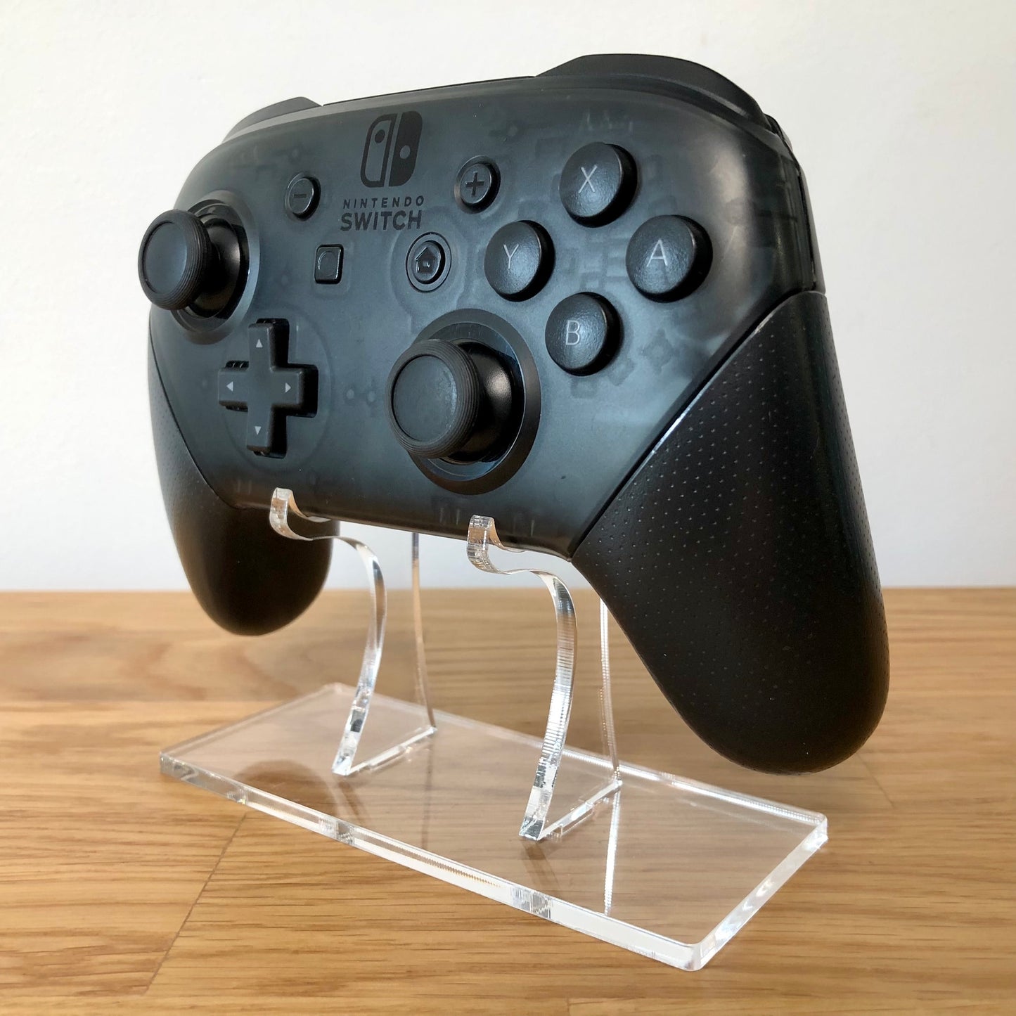 Front side view of Nintendo Switch Pro Controller, showing button layout and ergonomic design.