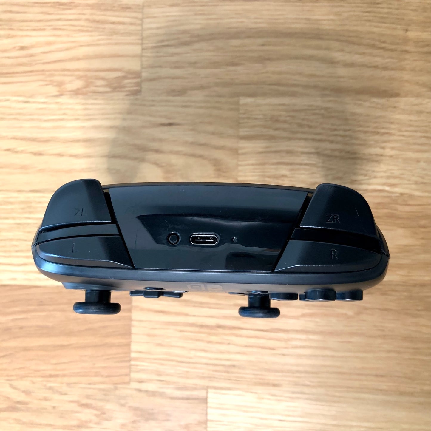 Top birds eye view of Nintendo Switch Pro Controller, highlighting the shoulder buttons.