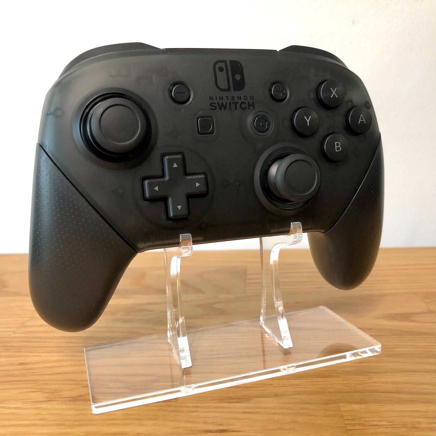 Front side view of Nintendo Switch Pro Controller, showing button layout and ergonomic design.