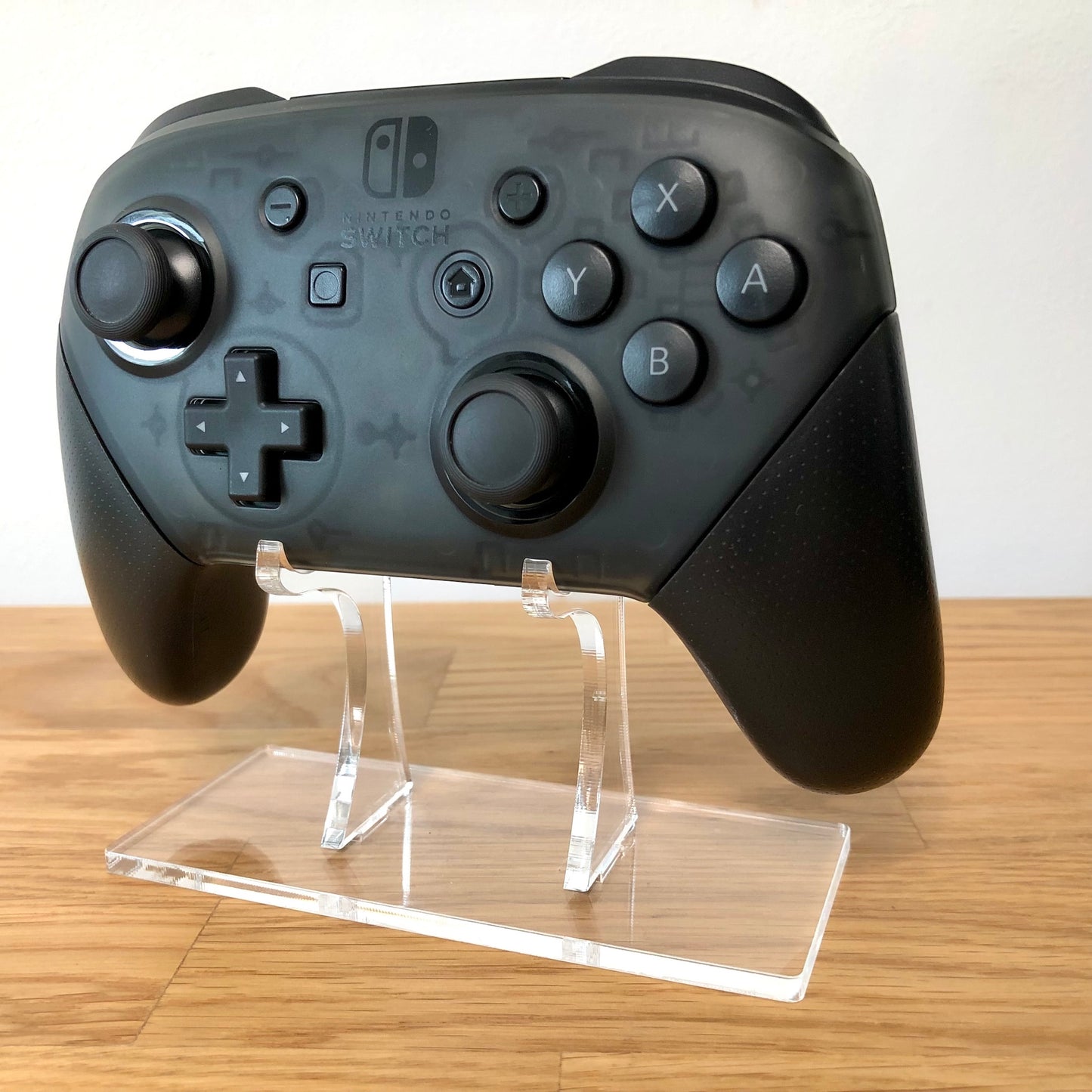 Front view of Nintendo Switch Pro Controller, showing button layout and ergonomic design.