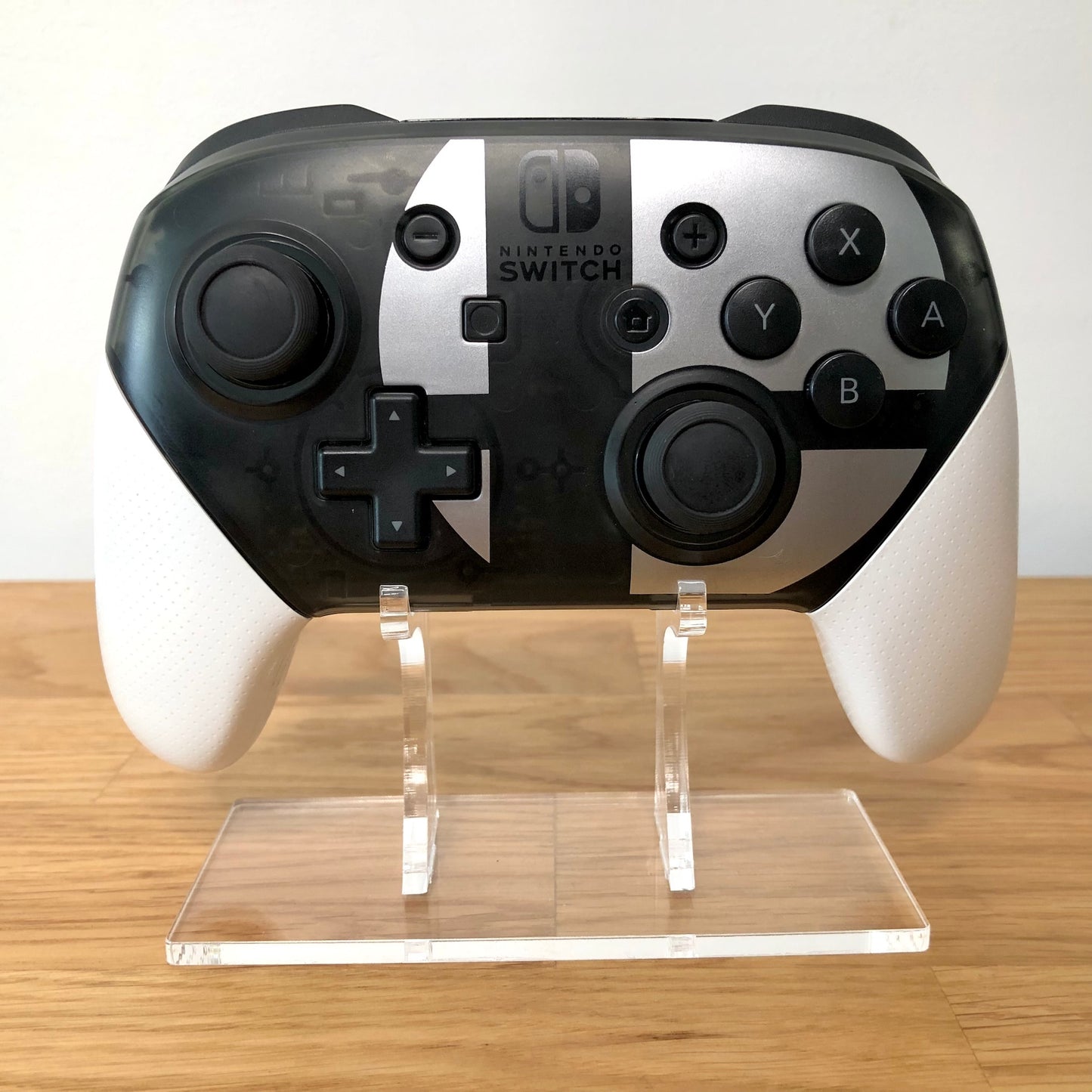 Front view of Nintendo Switch Pro Controller: Smash Bros. Edition, showing button layout and ergonomic design.