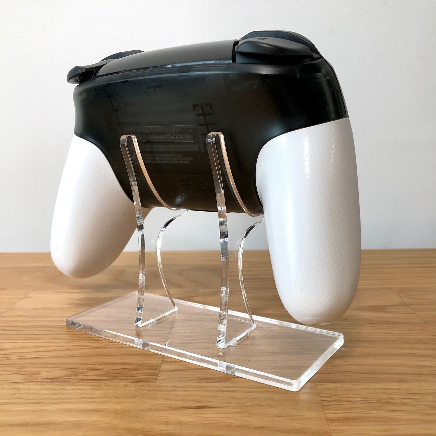 Back side view of Nintendo Switch Pro Controller Smash Bros. Edition, highlighting model details and rear design.