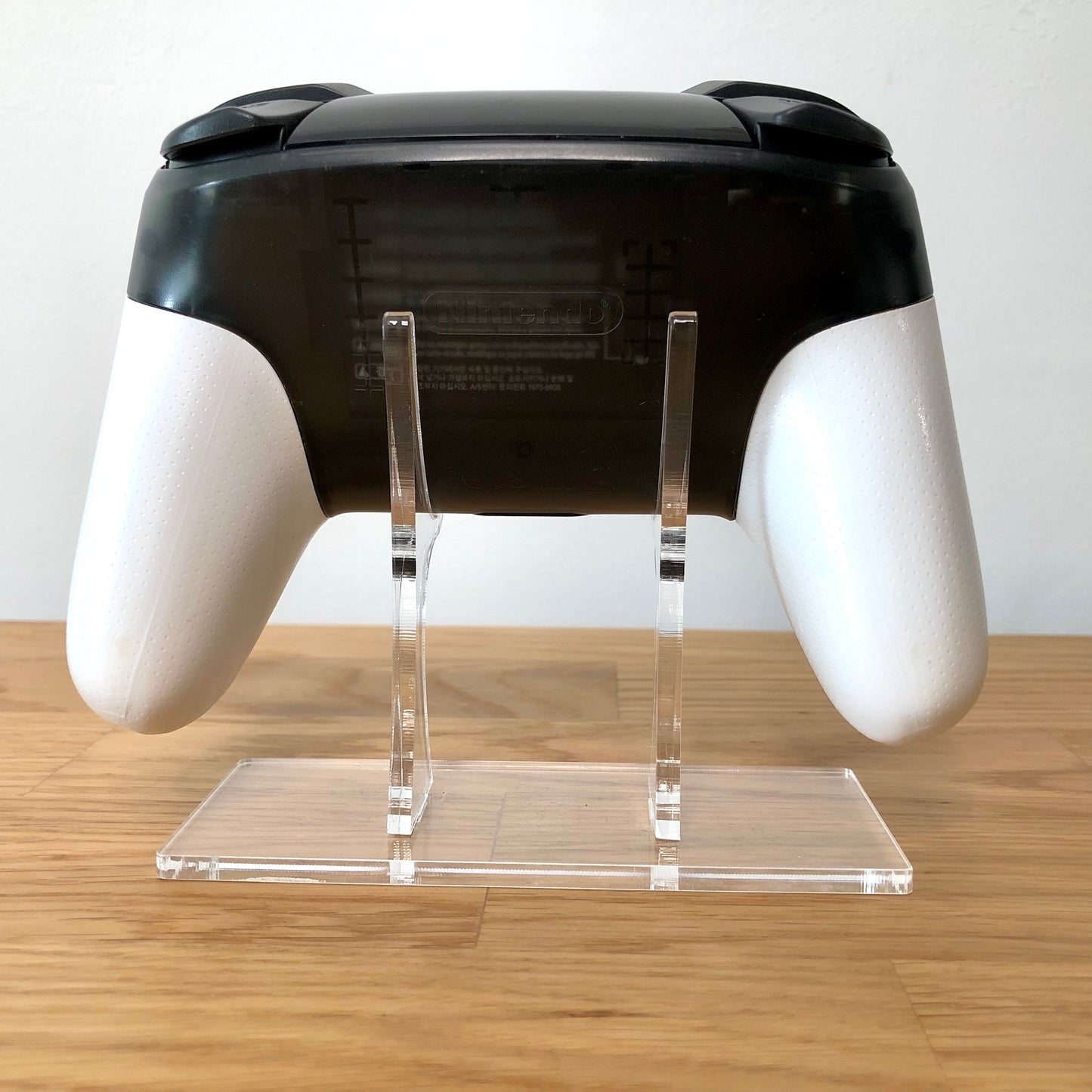 Back view of Nintendo Switch Pro Controller Smash Bros. Edition, highlighting model details and rear design.