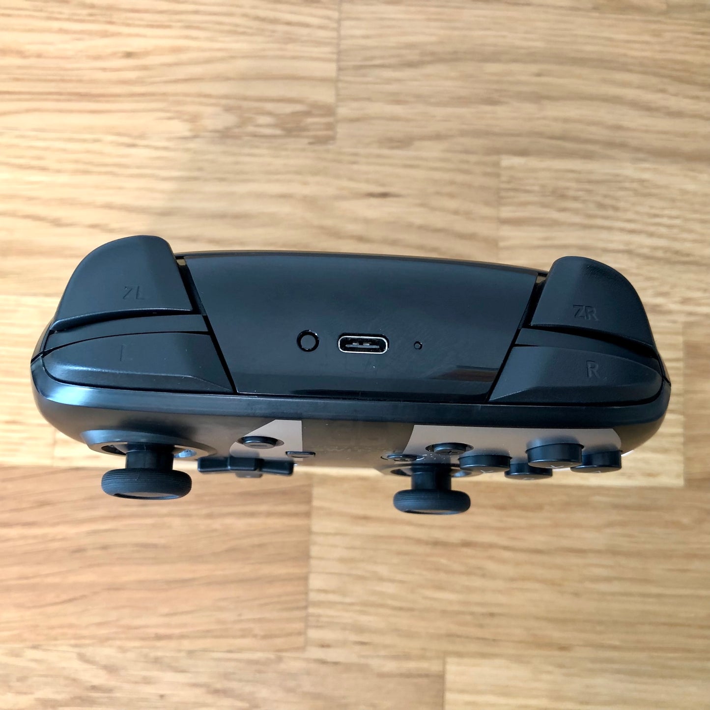 Birds eye top view of Nintendo Switch Pro Controller, highlighting shoulder buttons.
