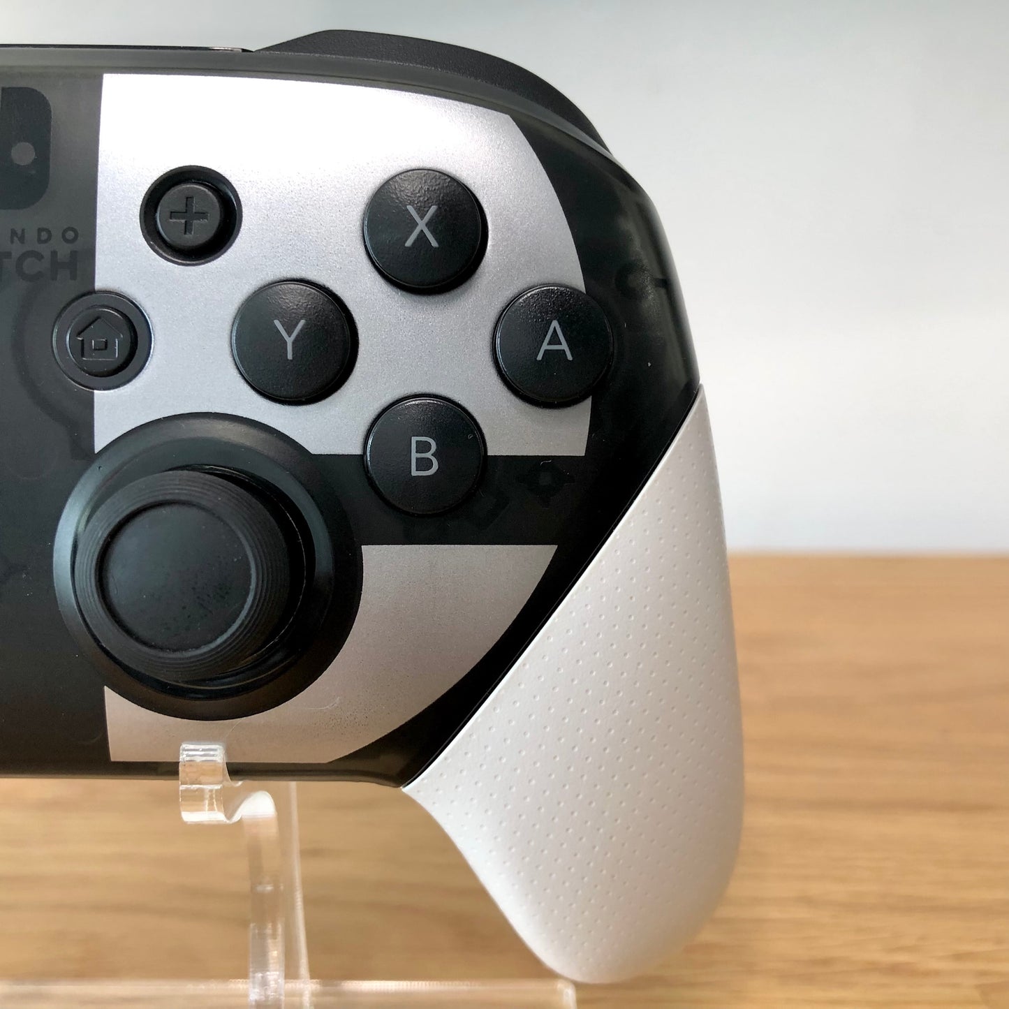 Close up view of Nintendo Switch Pro Controller Smash Bros. Edition right side. Highlighting the right side button's condition.