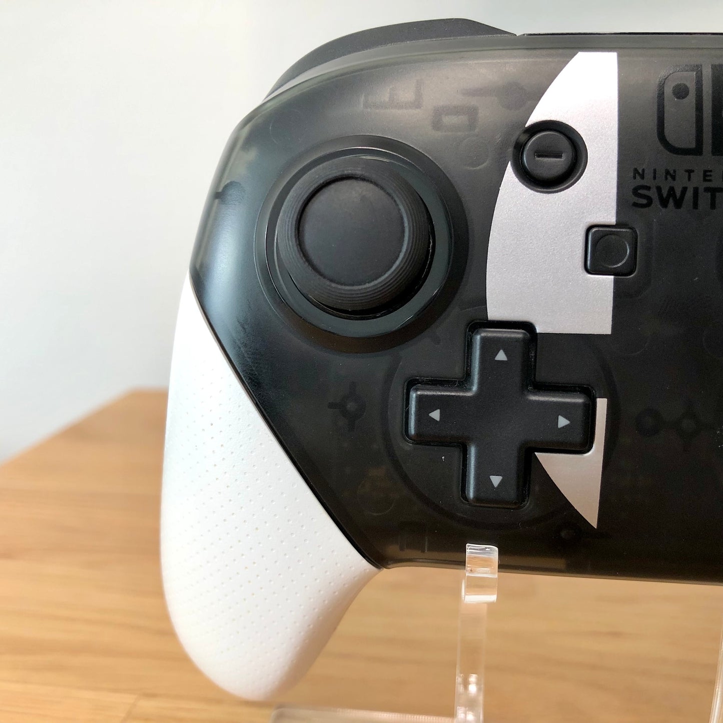 Close up view of Nintendo Switch Pro Controller Smash Bros. Edition left side. Highlighting the left side button's condition.