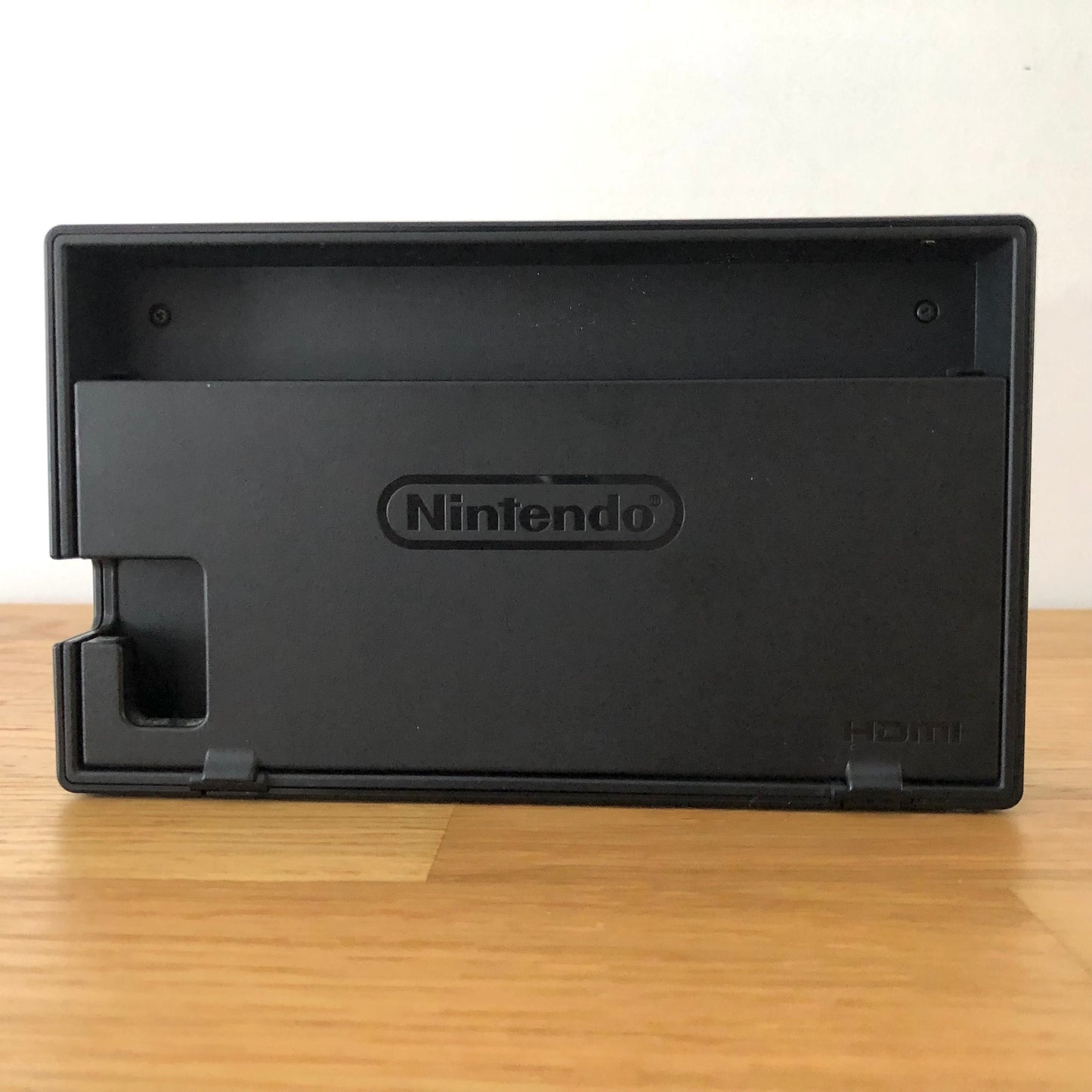 Rear of grey Nintendo Switch dock with HDMI branding and Nintendo logo, cable slot openings on left side
