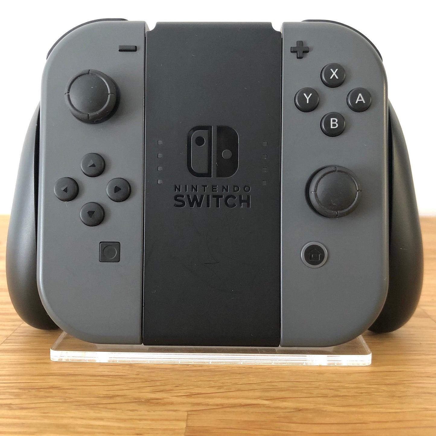 Front view of Joy-Con grip with grey Nintendo Switch Joy-Cons, showing all front facing buttons.
