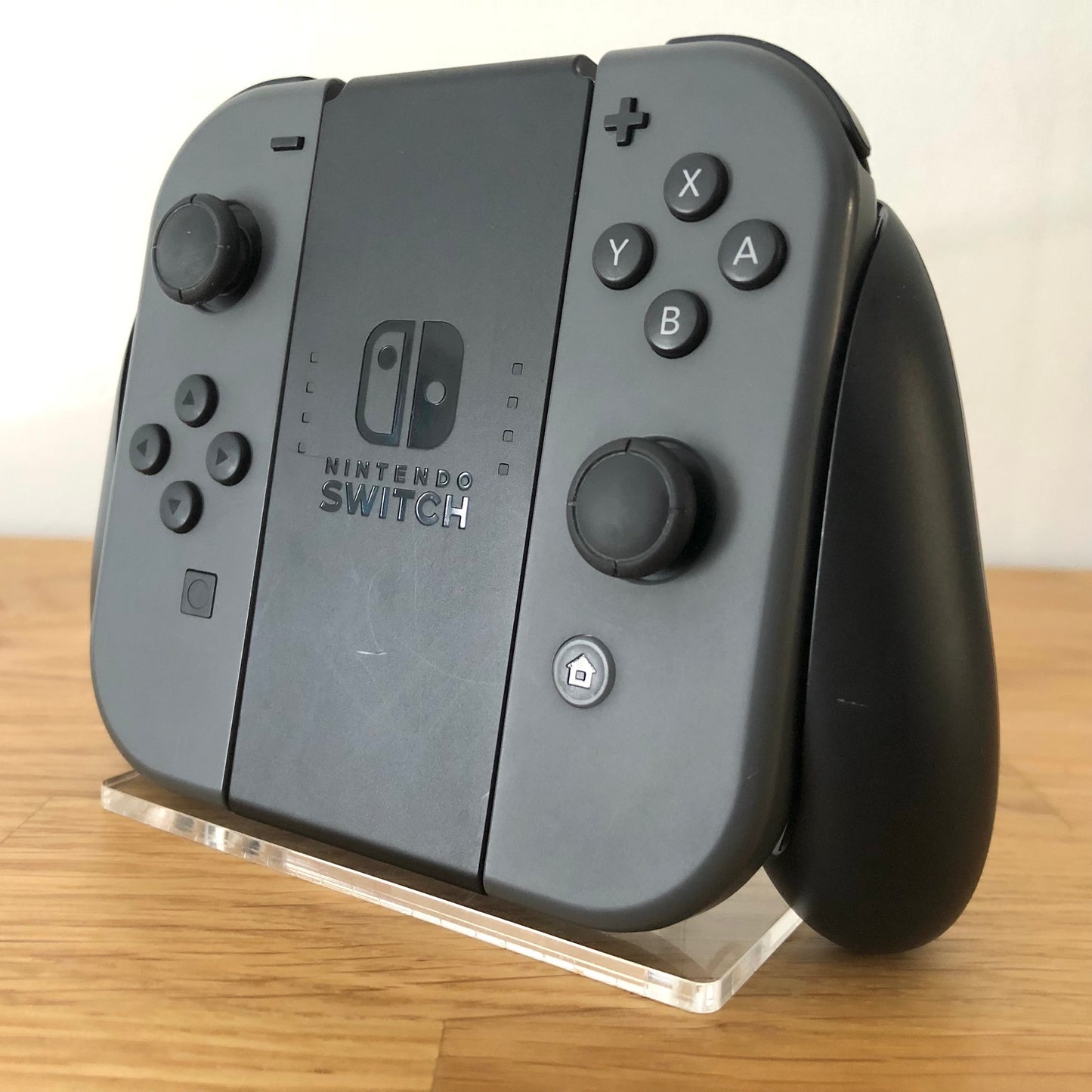 Angled right view of Joy-Con grip with grey Joy-Cons, showing all front facing buttons.