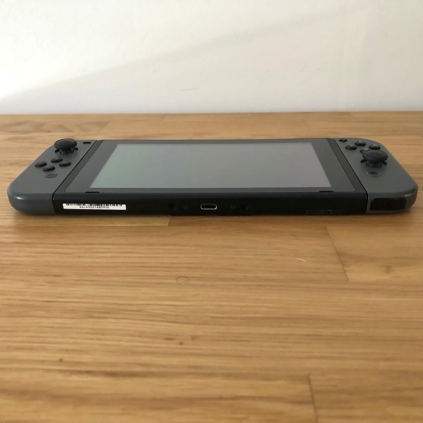 Bottom edge of Nintendo Switch showing USB-C port, speaker grills, and lower edge of both Joy-Cons.