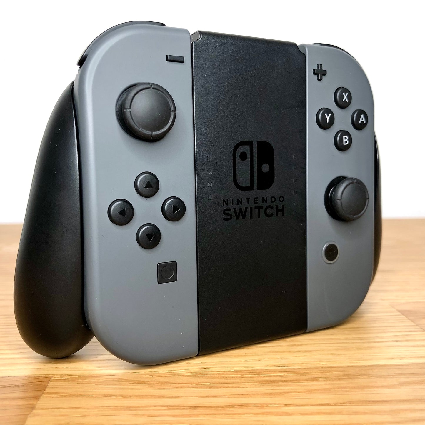 Angled right view of Joy-Con grip with grey Joy-Cons, showing all face buttons