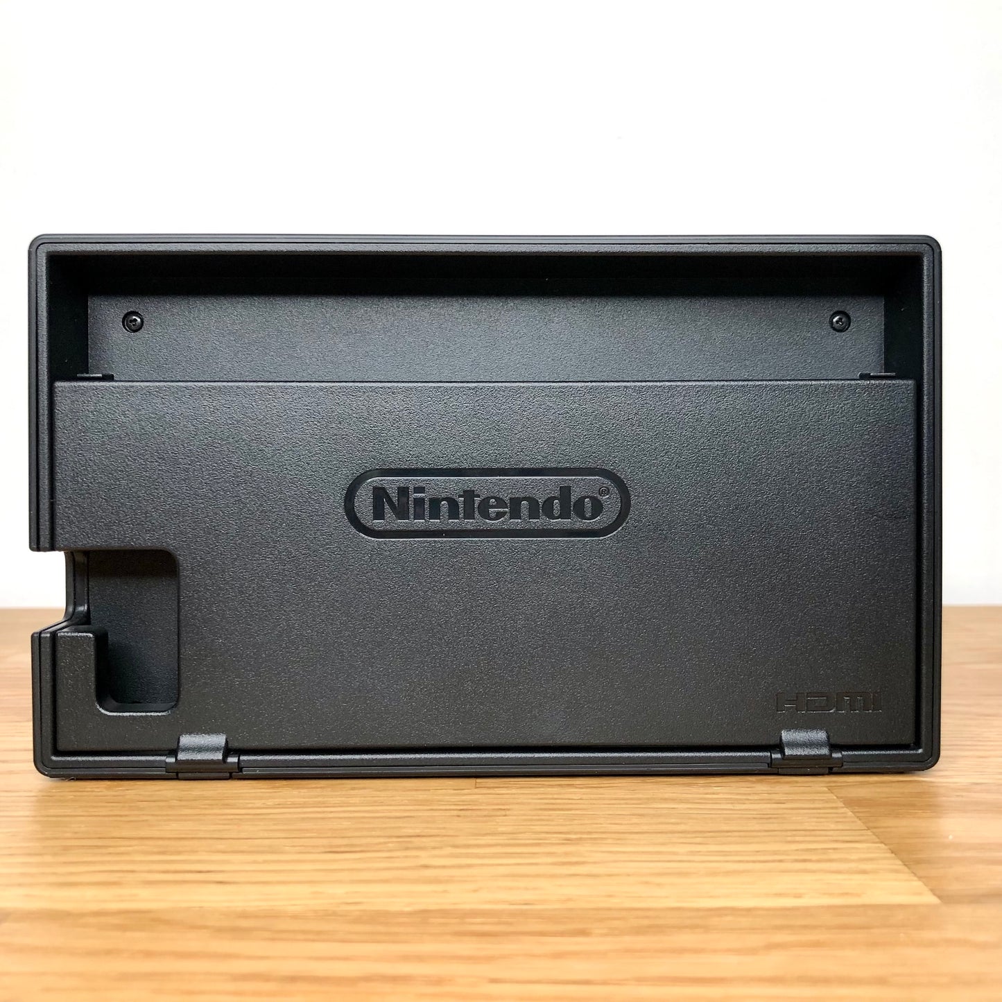 Rear of Nintendo Switch dock with HDMI branding and Nintendo logo, cable slot openings on left side.
