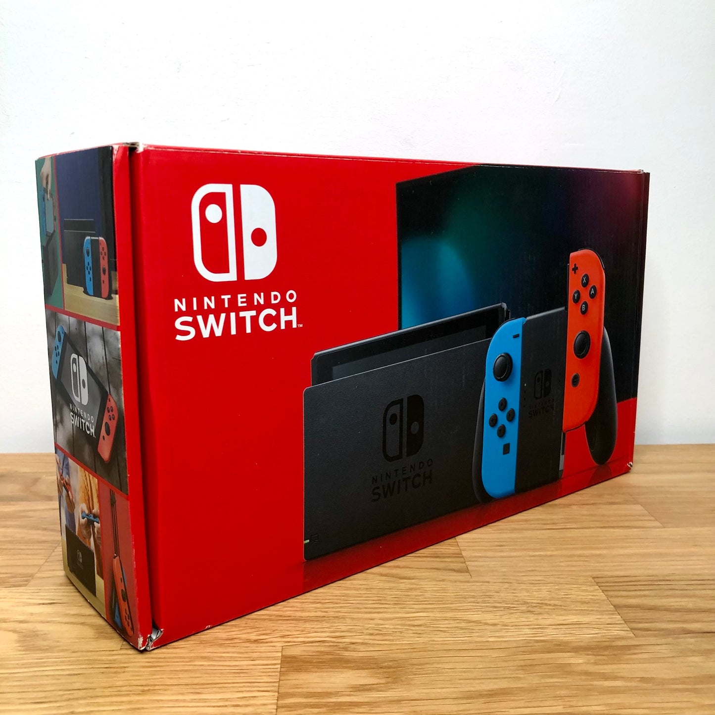 Angled side view of Nintendo Switch box showing branding, features and product images.