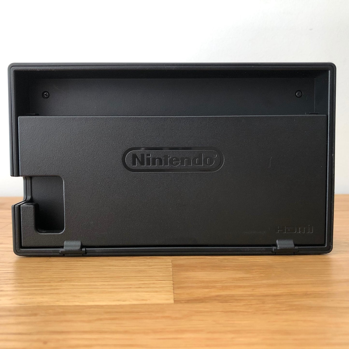 Rear of Nintendo Switch dock with HDMI branding and Nintendo logo, cable slot openings on left side.