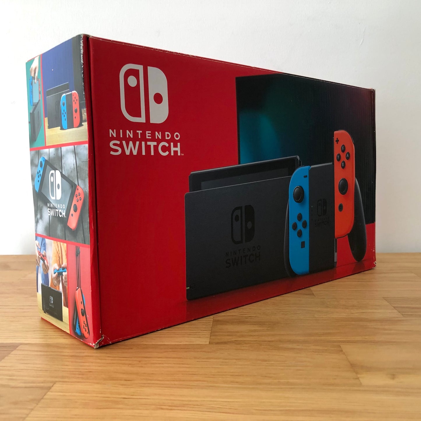 Angled side view of Nintendo Switch box showing branding, features and product images.